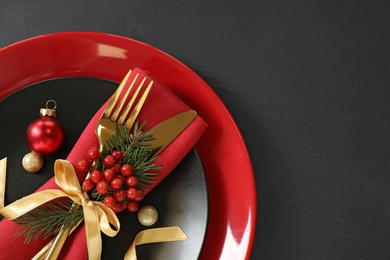 Beautiful Christmas table setting on black background, top view