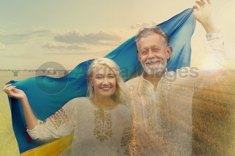 Double exposure of happy mature couple with national flag of Ukraine and wheat field
