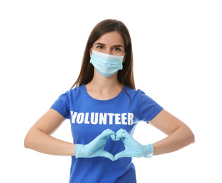 Female volunteer in protective mask and gloves showing heart gesture on white background. Aid during coronavirus quarantine