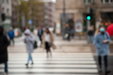 People at pedestrian crossing outdoors, blurred view
