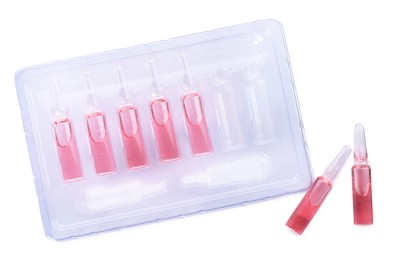 Tray with glass pharmaceutical ampoules on white background, top view