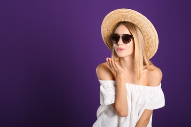 Beautiful woman in stylish sunglasses on purple background. Space for text