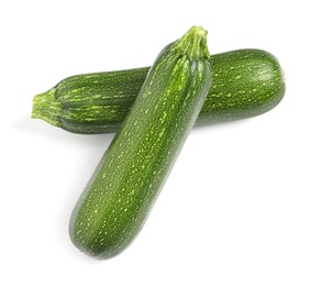 Raw ripe zucchinis on white background, top view