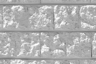 White rough stone wall as background, closeup