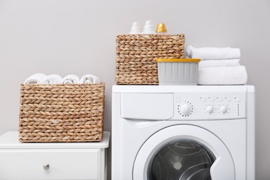 Laundry room with washing machine, detergents and clean towels. Tidying up method