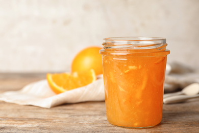 Homemade delicious orange jam on wooden table
