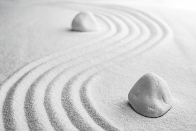White stones on sand with pattern. Zen, meditation, harmony