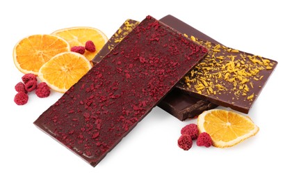Photo of Chocolate bars with freeze dried fruits, raspberries and orange slices on white background