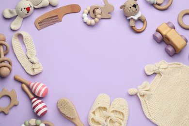 Photo of Frame of baby clothes and accessories on lilac background, flat lay. Space for text