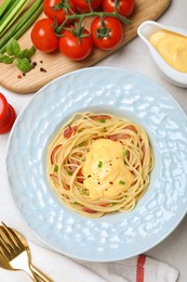 Delicious spaghetti with meat and cheese sauce served on light grey table, flat lay