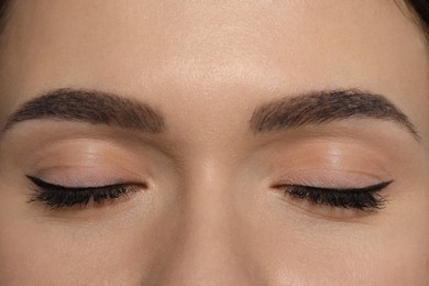 Photo of Young woman with permanent makeup of eyes and brows, closeup