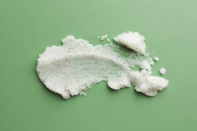 Sample of body scrub on green background, top view