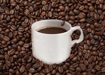 Image of Cup of tasty espresso and roasted coffee beans