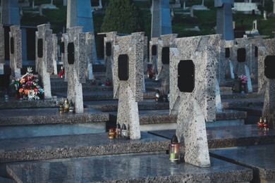 Many granite tombstones on cemetery. Funeral ceremony