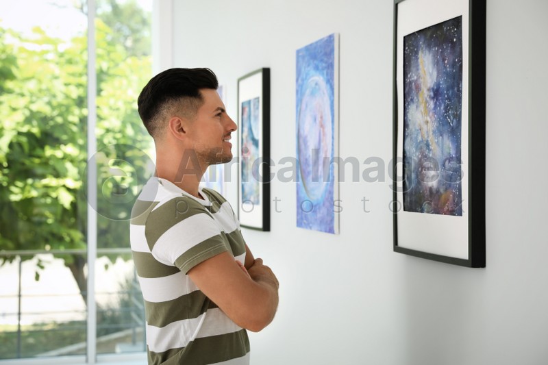 Happy man at exhibition in art gallery