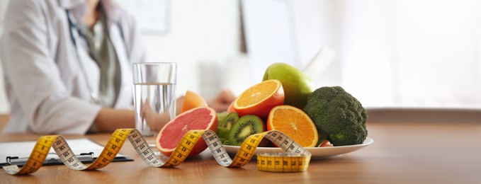 Healthy products, measuring tape and blurred nutritionist on background. Banner design