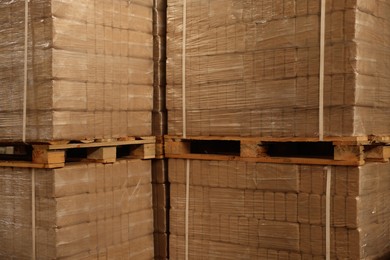 Stacks of merchandise wrapped in stretch film on wooden pallets