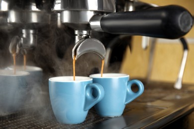 Making fresh aromatic espresso using professional coffee machine