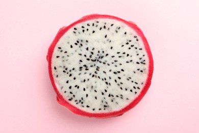 Photo of Delicious cut dragon fruit (pitahaya) on pink background, top view