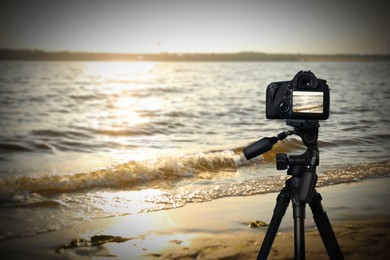 Taking photo of beautiful seascape with camera mounted on tripod