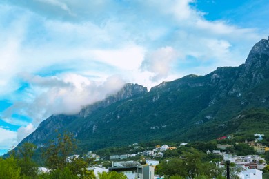 Photo of Picturesque view of mountain landscape and city