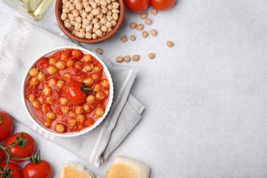 Photo of Delicious chickpea curry on light gray table, flat lay. Space for text