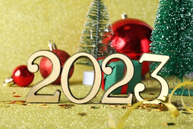 Number 2023 and festive decor on bright background. Happy New Year
