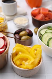 Photo of Ingredients for poke bowl on white checkered table