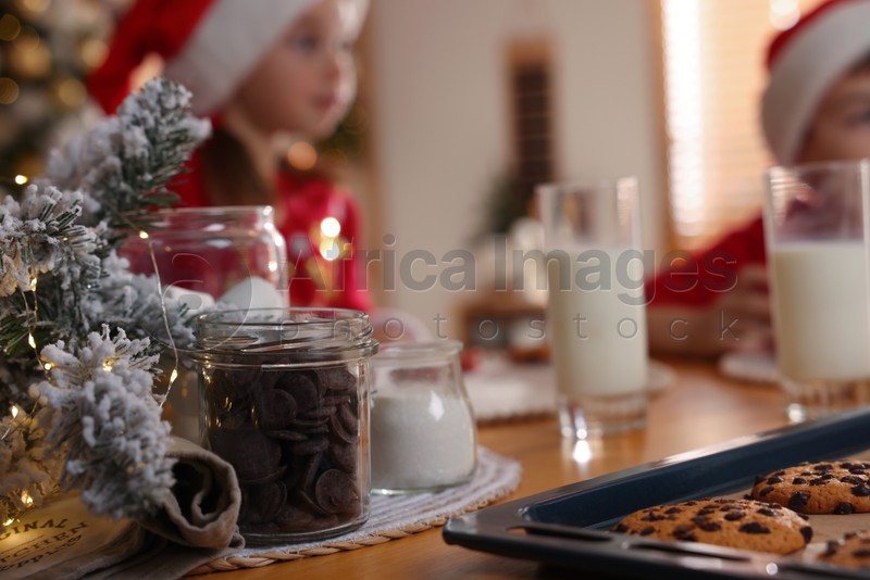 Cute little children with delicious Christmas cookies at home, focus on pastry