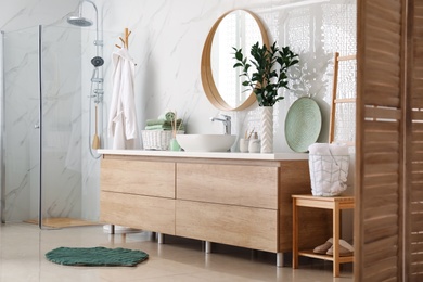 Photo of Modern bathroom interior with stylish mirror and vessel sink