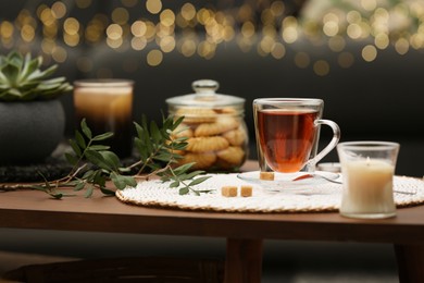 Tea, cookies and decorative elements on wooden table indoors