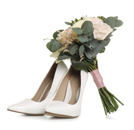 Pair of wedding high heel shoes and beautiful bouquet on white background