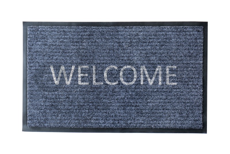 Grey door mat with word WELCOME isolated on white, top view