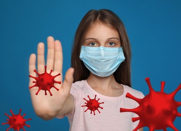 Stop Covid-19 outbreak. Little girl wearing medical mask surrounded by virus on blue background