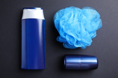 Shower gel, deodorant and bast wisp on black background, flat lay. Men's cosmetics