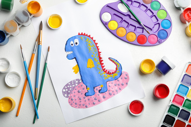 Flat lay composition with child's painting of dinosaur on white table