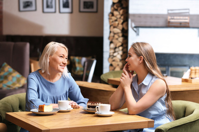 Mother and her adult daughter spending time together in cafe