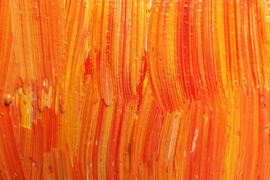 Photo of Strokes of colorful oil paints as background, closeup