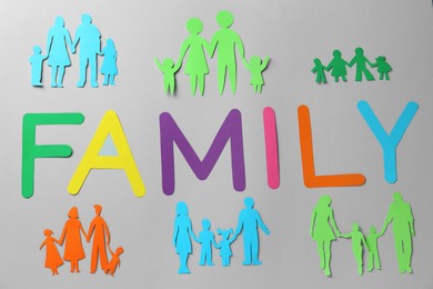 Paper cutouts and word Family made of colorful letters on grey background, flat lay