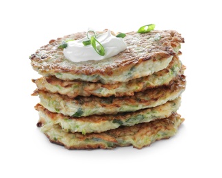 Stack of delicious zucchini fritters with sour cream and green onion on white background
