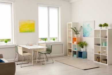 Photo of Stylish dining room interior. Home design idea