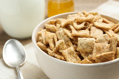 Bowl of sweet crispy breakfast cereal on table, closeup
