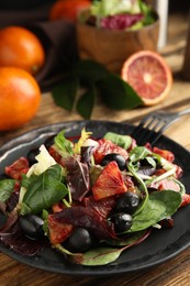 Delicious salad with sicilian orange on wooden table, closeup