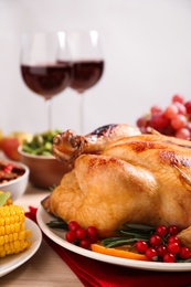 Traditional Thanksgiving day feast with delicious cooked turkey and other seasonal dishes served on table, closeup