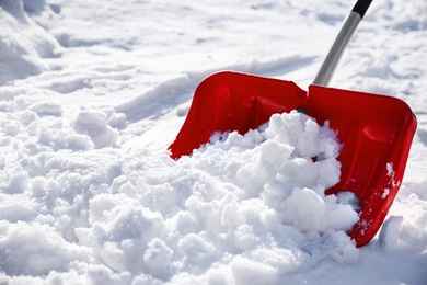 Shoveling snow outdoors on sunny winter day, closeup