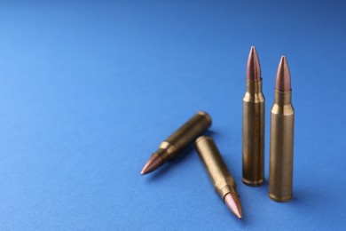 Bullets on blue background, closeup. Space for text