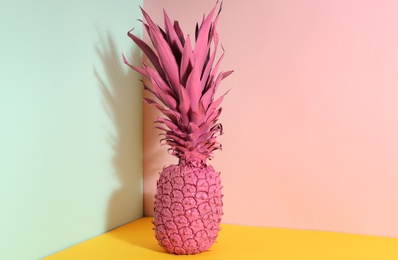 Photo of Pink pineapple on color background. Creative concept