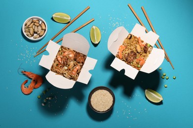 Boxes of wok noodles with seafood and chopsticks on turquoise background, flat lay
