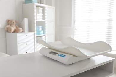 Modern digital baby scales on table in clinic
