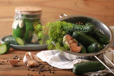 Fresh cucumbers, dill, peppercorns and garlic on wooden table. Pickling recipe
